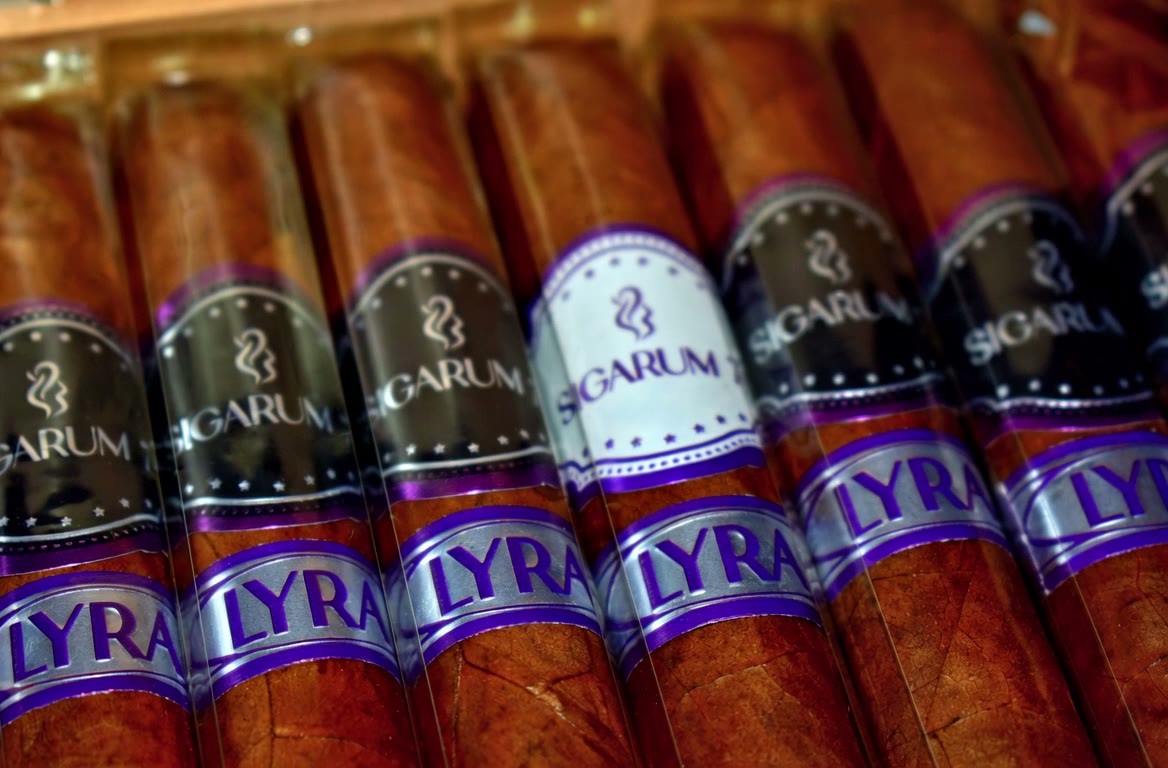 Lyra Churchill cigars resting in the open box